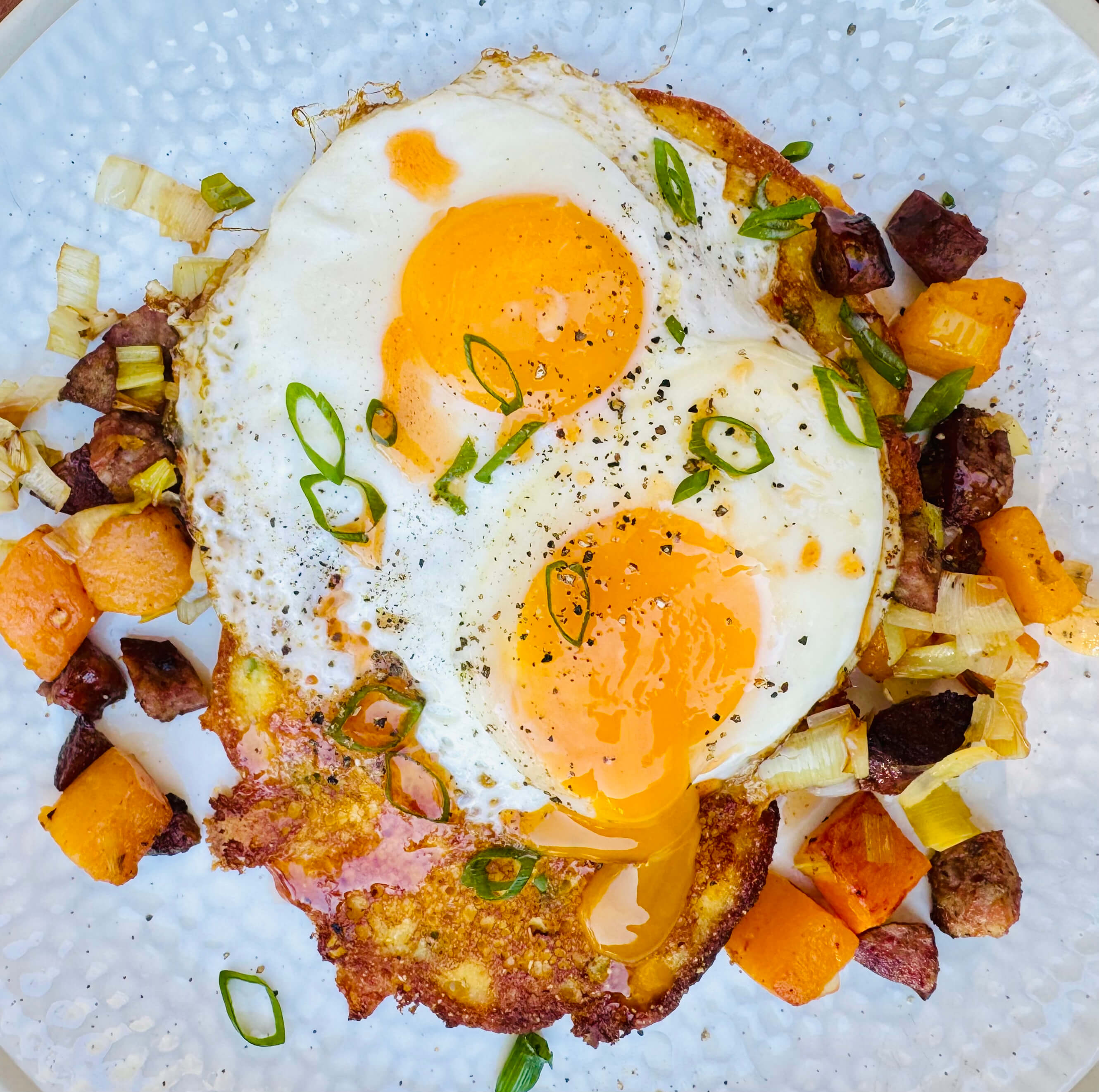 Cornmeal Hoecakes with Smoked Sausage Hash and Fried Eggs